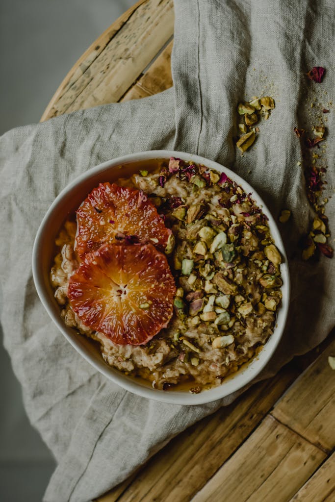 Delicious breakfast bowl featuring blood orange slices and crunchy pistachios, perfect for a nutritious start.
